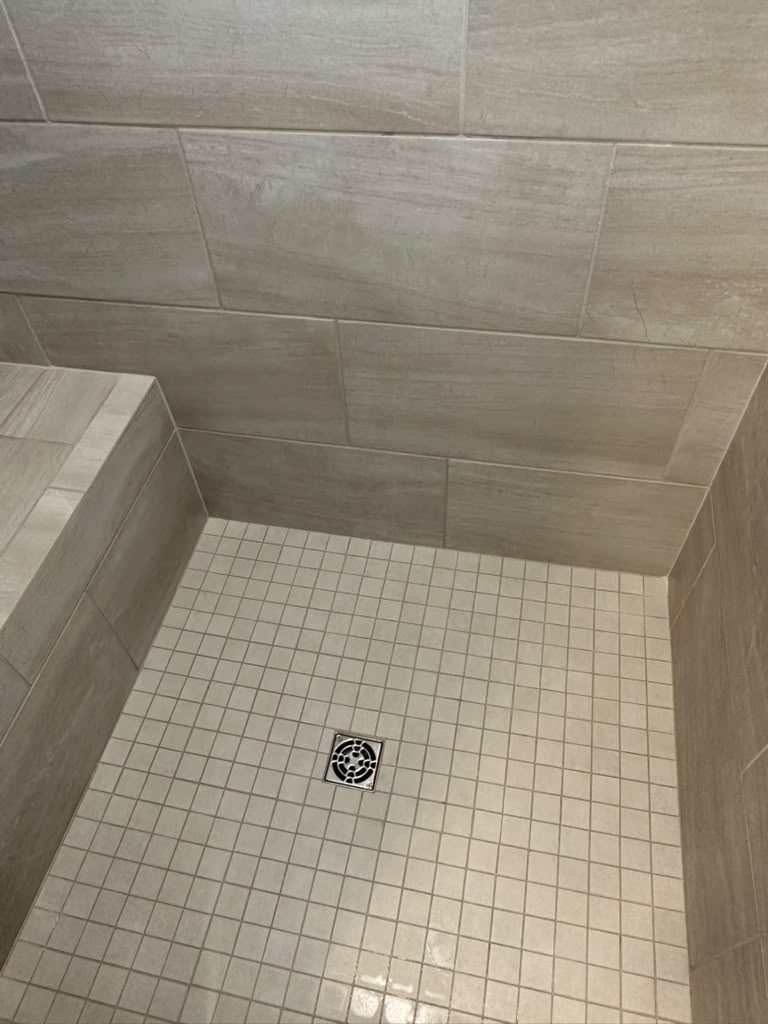 Freshly cleaned walk-in shower with glossy tile