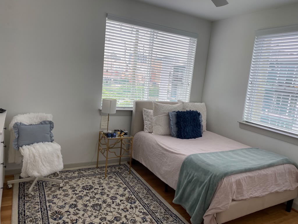 Cozy bedroom with tidy carpet and made bed after a cleaning service